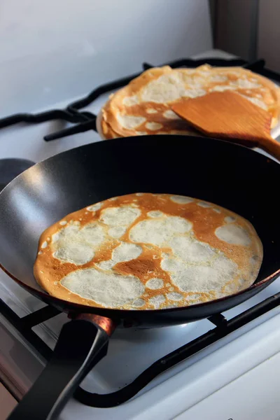 Baking the pancake in a frying pan.