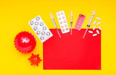 Different drugs, medicines tablets syringes against coronavirus, blood cancer, leukemia. Copy space on red, yellow background. Chinese Coronavirus, WUHAN virus, Coronavirus outbreak, influenza.