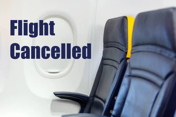 Flight cancelled. Coronavirus, warning sign with text Flight Cancelled in empty airplane cabin. Cancelled flight, no travel, stop airline for prevention coronavirus pandemic. COVID19 quarantine.