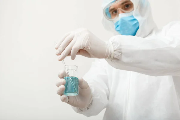 Coronavirus, covid-19. Doctor or scientist in protective medical suit, biological hazard, face mask creating vaccine in laboratory on gray background. Medical healthcare pandemic prevention concept