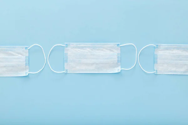 Medical mask, Medical protective masks on blue background. Disposable surgical face mask cover the mouth and nose. Healthcare and medical concept. — ストック写真