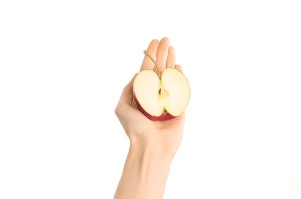 Healthy eating and diet Topic: Human hand holding a half of red apple isolated on a white background in the studio, first-person view — Stock Photo, Image