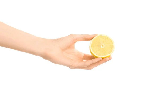 Healthy eating and diet Topic: Human hand holding half of lemon isolated on a white background in the studio — Stock Photo, Image
