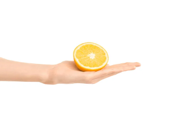 Healthy eating and diet Topic: Human hand holding a half of orange isolated on a white background in the studio — Stock Photo, Image