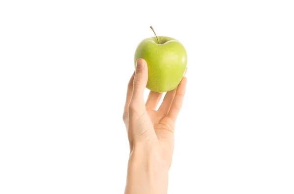 Тема: Человеческая рука, держащая зеленое яблоко на белом фоне в студии, вид от первого лица — стоковое фото