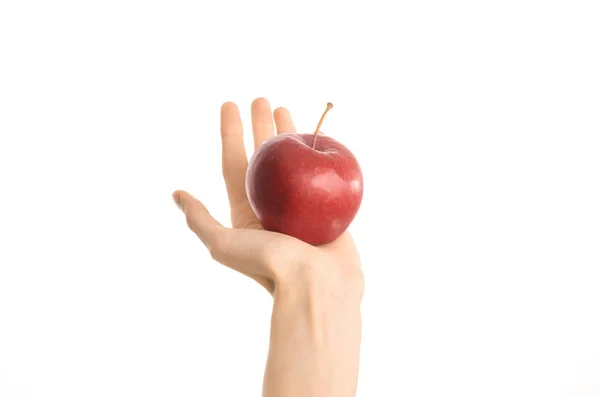 Healthy eating and diet topic: human hand holding a red apple isolated on a white background in the studio, first-person view — Stock Photo, Image