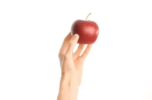 Healthy eating and diet topic: human hand holding a red apple isolated on a white background in the studio, first-person view — Stock Photo, Image