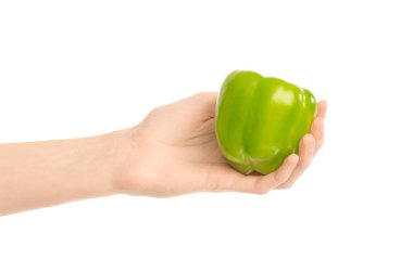 Sağlıklı beslenme ve diyet Konu: beyaz bir arka planda stüdyoda izole bir yeşil biber tutan eller