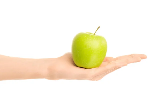 Healthy eating and diet Topic: Human hand holding a green apple isolated on a white background in the studio — Stock Photo, Image