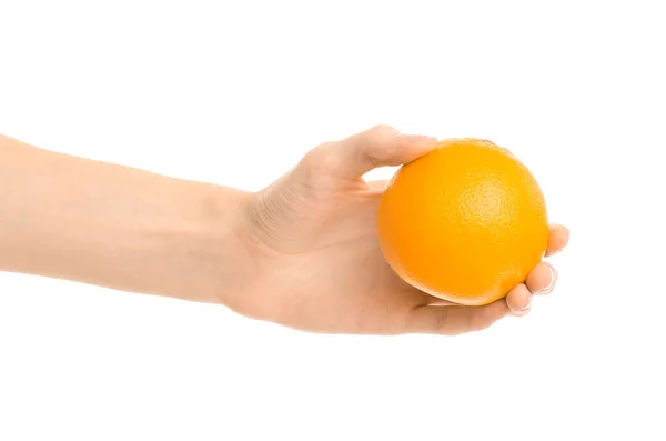 Healthy eating and diet Topic: Human hand holds a ripe orange isolated on a white background in the studio — Stock Photo, Image