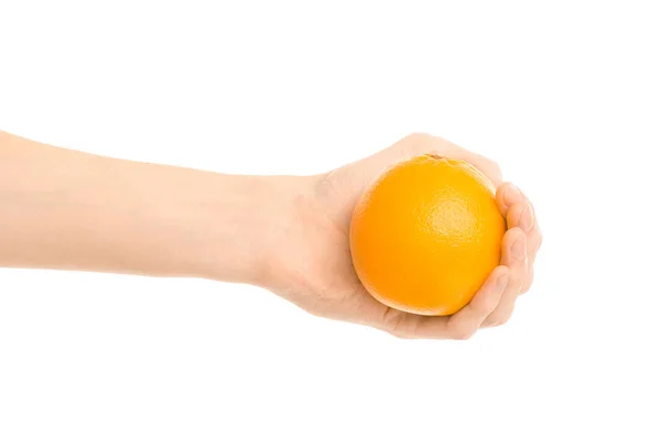 Healthy eating and diet Topic: Human hand holds a ripe orange isolated on a white background in the studio — Stock Photo, Image