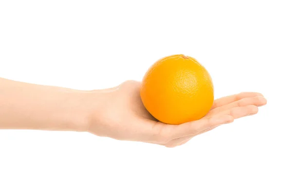 Healthy eating and diet Topic: Human hand holds a ripe orange isolated on a white background in the studio — Stock Photo, Image