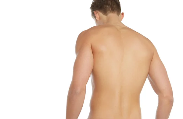 Спорт и фитнес тема: голый спортсмен, стоящий в стороне изолированный на белом фоне в студии, человеческая анатомия — стоковое фото