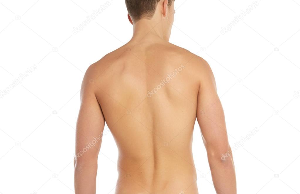 Sports and fitness topic: naked sporty man standing back isolated on a white background in the studio, human anatomy