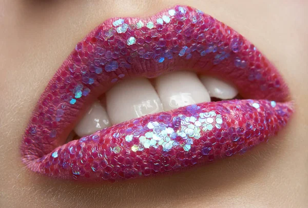 Macro and close-up creative make-up theme: beautiful female lips pink lipstick and sequins, retouched photo — Stock Photo, Image