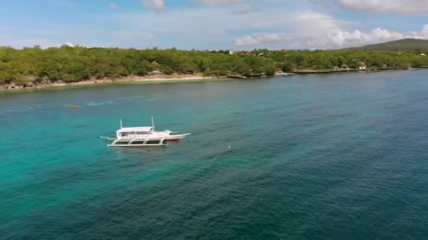 Vista aérea de cima barco turístico em um mar azul ou oceano com água azul clara calma. Vista de cima — Vídeo de Stock