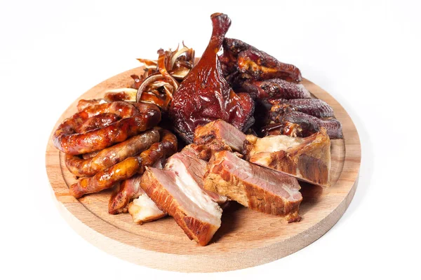 Appetizing set of smoked meat: spiral fried sausage, chicken leg, buffalo chicken wings, sliced smoked meat. On a wooden tray. On a white background in isolation.