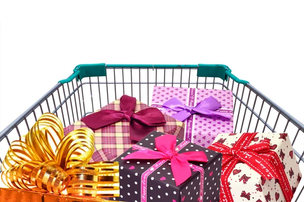 Presents ribbon and gift box in shopping trolley cart  on white background — Stock Photo, Image
