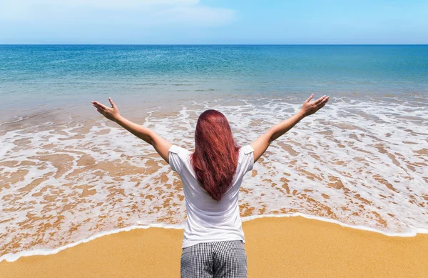 Asian woman standing raised up arms celebrate success on the beach — Stockfoto