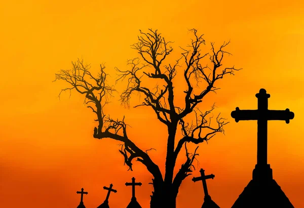 scary silhouette dead tree and spooky silhouette crosses in mystic graveyard