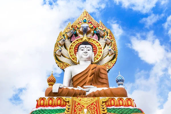 big buddha statue sitting in public thai temple