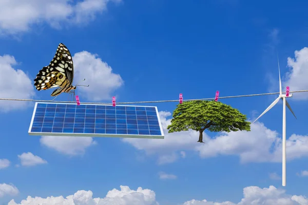 Panel solar y turbina eólica y árbol colgando en la línea de ropa con mariposa —  Fotos de Stock