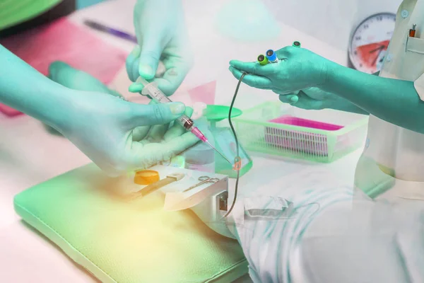 Double exposure nurse pricking needle syringe in the arm patient drawing blood