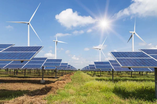 solar cells with wind turbines generating electricity in hybrid power plant systems station on blue sky background alternative renewable energy from nature  Ecology concept.