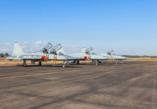 fighter jet military aircrafts parked on runway in the base airforce on blue sky background