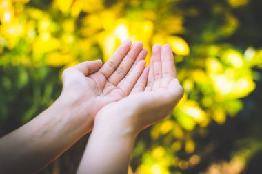 Boş kadın eli yeşil bokeh arka planda..