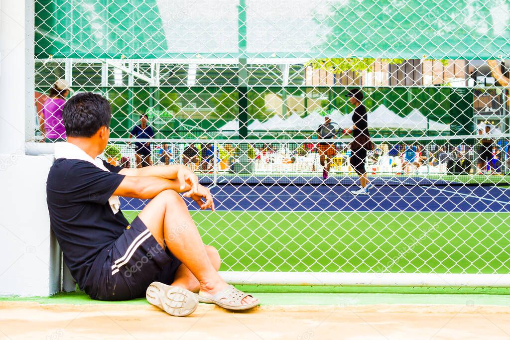 Men to watch from the outside of the wire mesh sports (competition sports tennis)