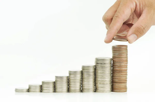 Hand put money on pile of coins isolated — Stock Photo, Image