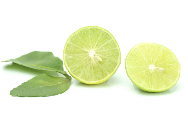 Limão verde com folhas isoladas no fundo branco — Fotografia de Stock
