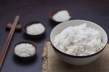 Ahşap arka plan üzerinde yemek çubukları ile Tayland pirinç