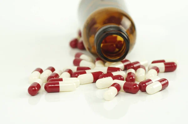 Capsule and glass bottle  on white background — Stock Photo, Image