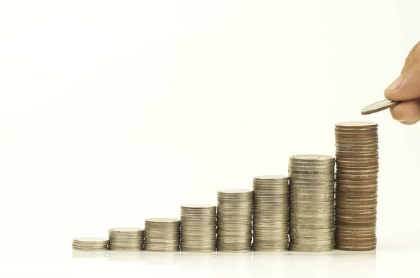 Hand put money on pile of coins  isolated on white background — Stock Photo, Image