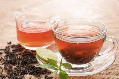 Fincan sıcak çay dilim limon üzerinde mola hızlı ve içme süresi sabah için kenevir çuval ile