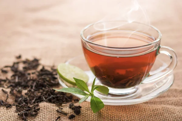 Fincan sıcak çay dilim limon üzerinde mola hızlı ve içme süresi sabah için kenevir çuval ile