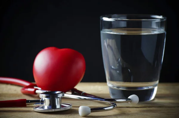 Stethoscope, red heart and drinking pure water for healthy