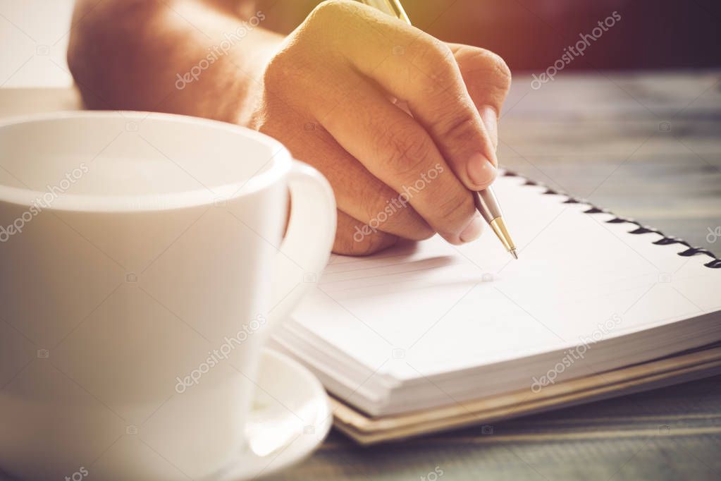 Writing dairy on notebook in coffee shop, concept as memory of life and education