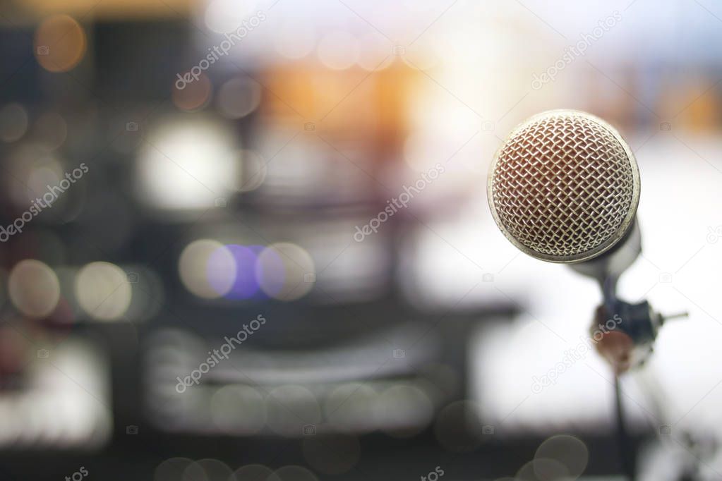 microphone and bokeh background, concept as music instrument in studio room and meeting hall