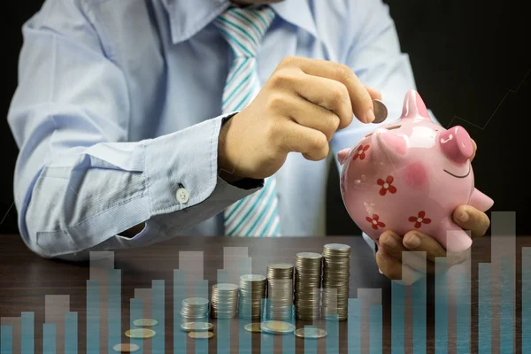 Businessman put money coins on piggy bank, safe and ivesting con — Stock Photo, Image