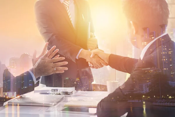 Business people shaking hand to cooperate and deal in business s