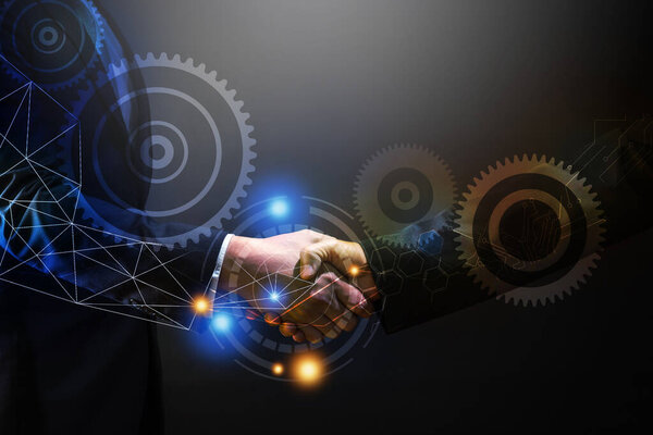 close up business man shake hand  with customer, connection technology in dark tone on black background 