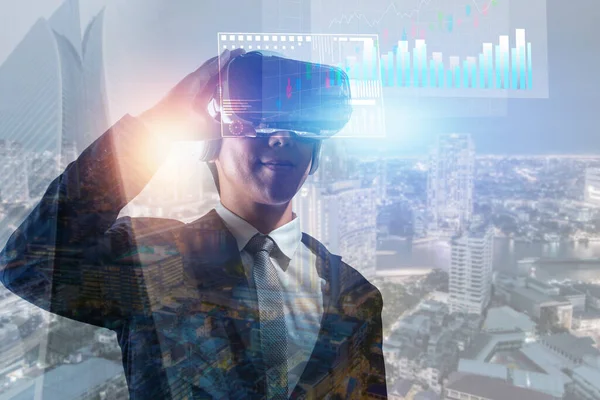 Technology and digital business innovation concept, Businessman wearing glasses of virtual reality goggles.Double exposure with city