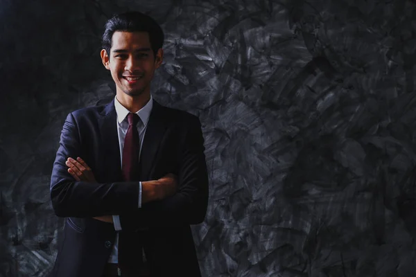 Young leader and businessman portrait on dark background, confidence and happy smart man