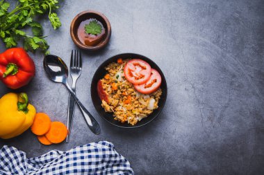 Kızarmış pirinç, doğal beslenme ve koyu çimento zemin zemininde taze sebzeler, temiz yeme konsepti ve menü için sağlıklı bir yemek.