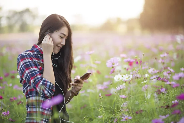 Unga hipster flicka Lyssna på musik i hörlurar i ett kosmos — Stockfoto