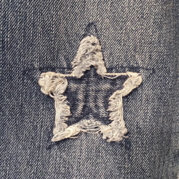 Yakın çekim yıldız Denim Jeans doku yırtık şeklinde