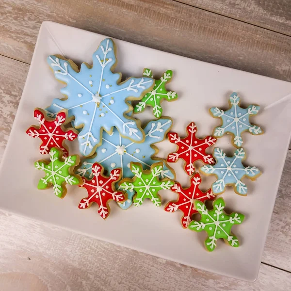 Top down view of mini snowflake sugar cookies for winter or chri — Stock Photo, Image